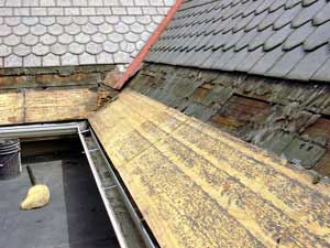 Copper Snow Aprons at slate roof central - exposing the roof deck