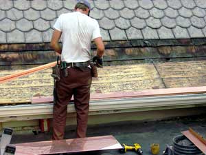 Copper Snow Aprons at slate roof central - drip edge being installed