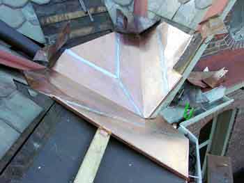 Copper Snow Aprons at slate roof central - custom lock-seam soldered piece