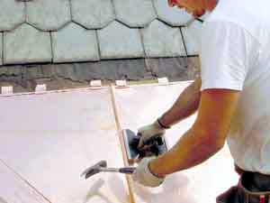 Copper Snow Aprons at slate roof central - standing seams being locked together