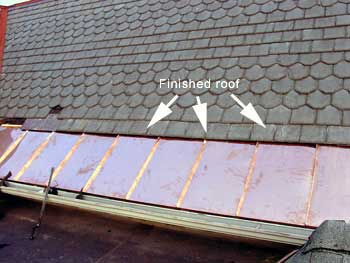 Copper Snow Aprons at slate roof central - standing seam apron installed